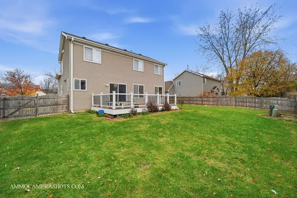 a view of a house with a yard and sitting area