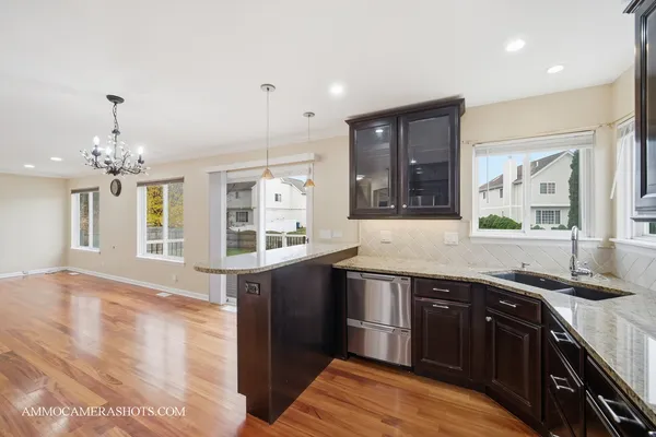 a kitchen with stainless steel appliances granite countertop a sink and cabinets