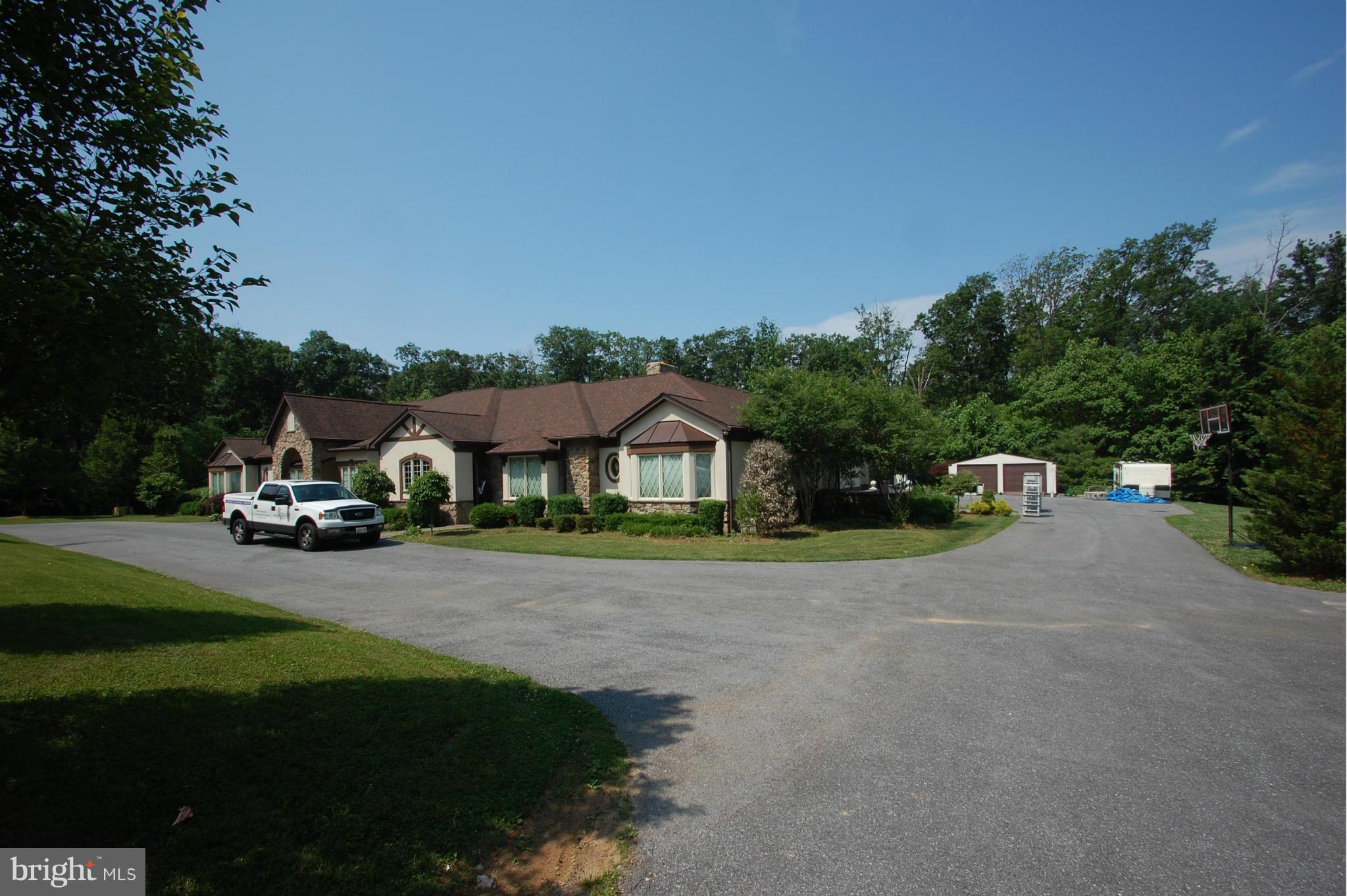 3840 Hooper Road New Windsor, MD 21776 - Photo 12 of 30 a front view of a house with a garden and tree