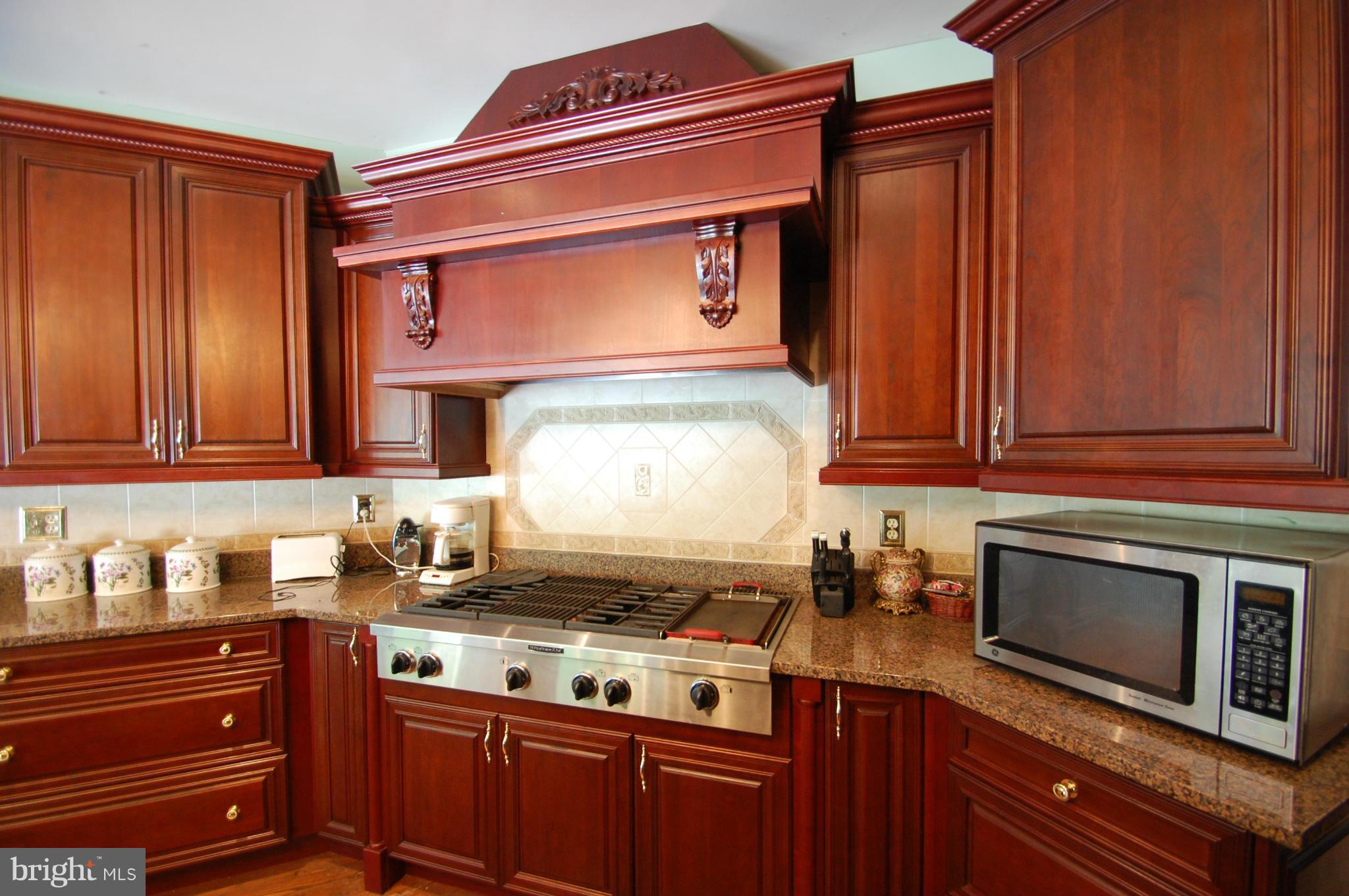 3840 Hooper Road New Windsor, MD 21776 - Photo 15 of 30 a kitchen with stainless steel appliances granite countertop a stove a microwave and cabinets