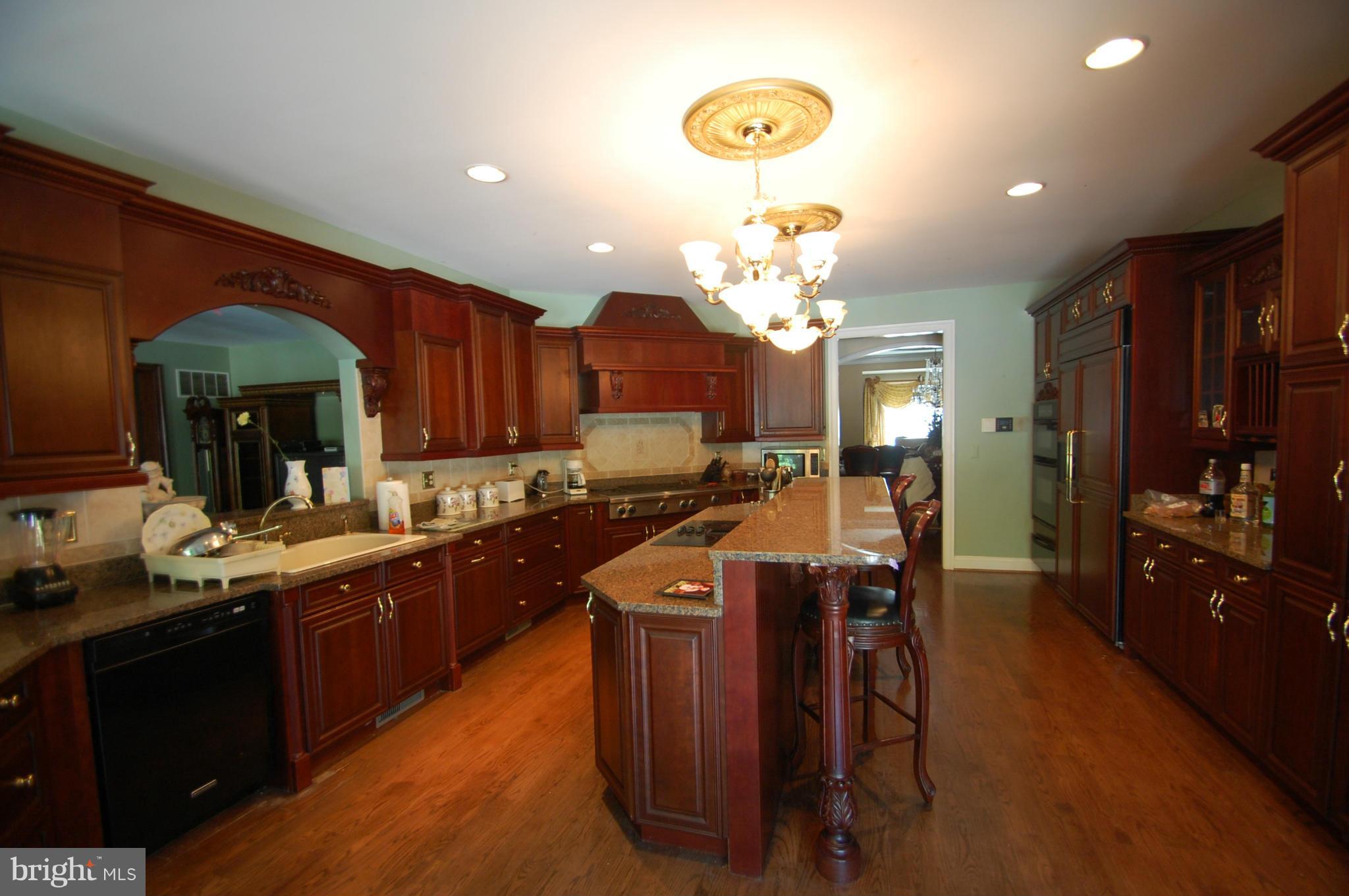 3840 Hooper Road New Windsor, MD 21776 - Photo 16 of 30 a kitchen with stainless steel appliances a table and chairs in it