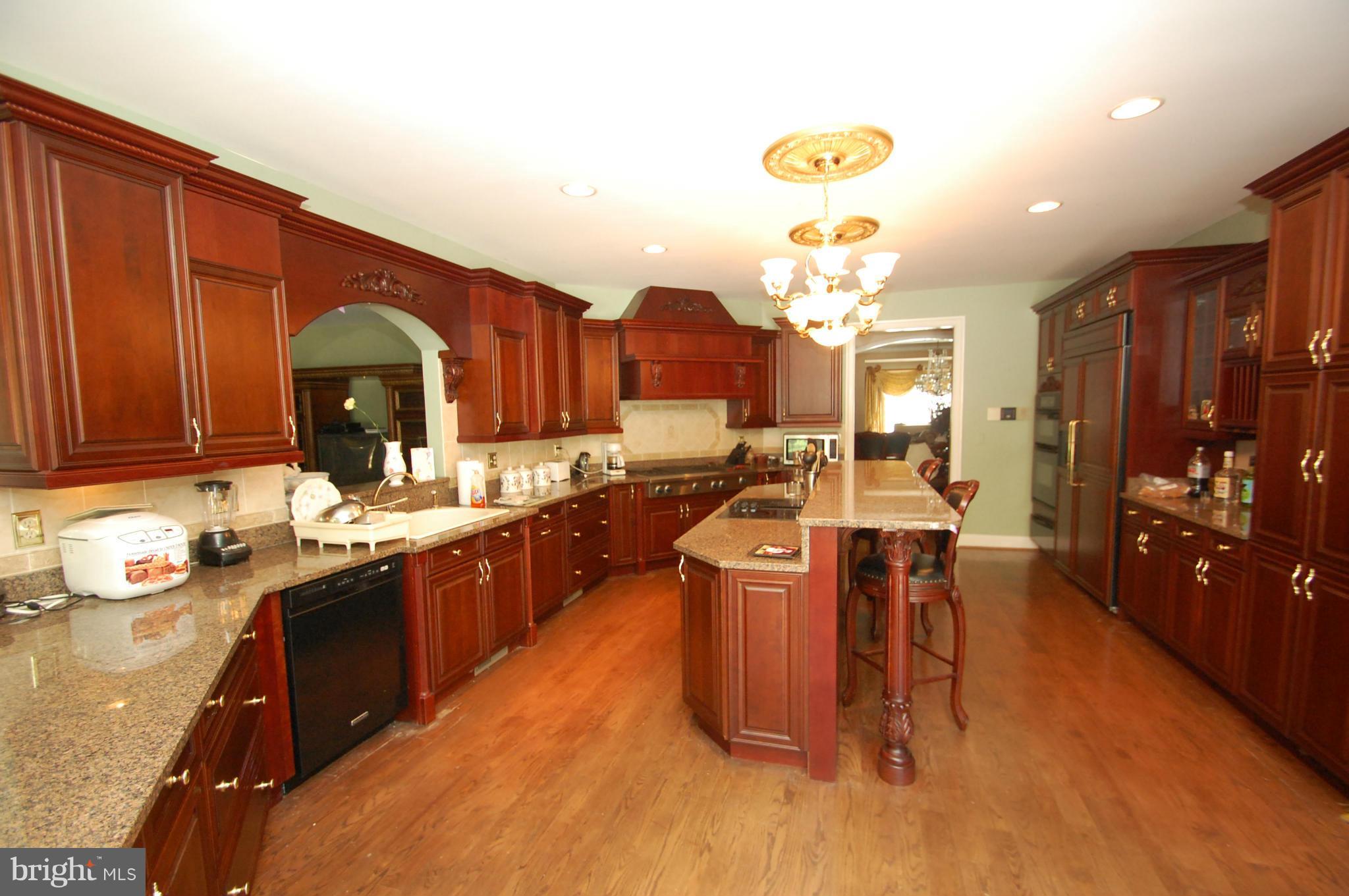3840 Hooper Road New Windsor, MD 21776 - Photo 17 of 30 a kitchen with stainless steel appliances granite countertop a sink stove and cabinets