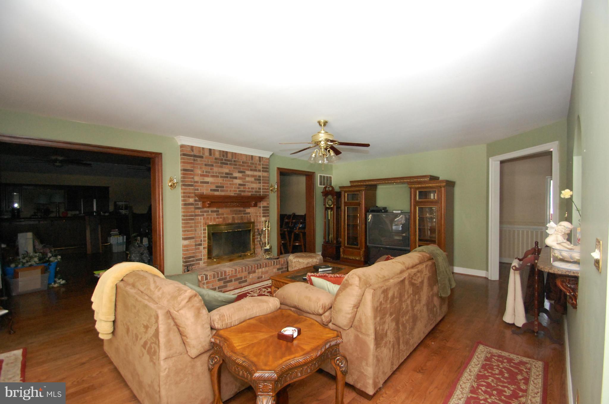 3840 Hooper Road New Windsor, MD 21776 - Photo 19 of 30 a living room with furniture a fireplace and a chandelier