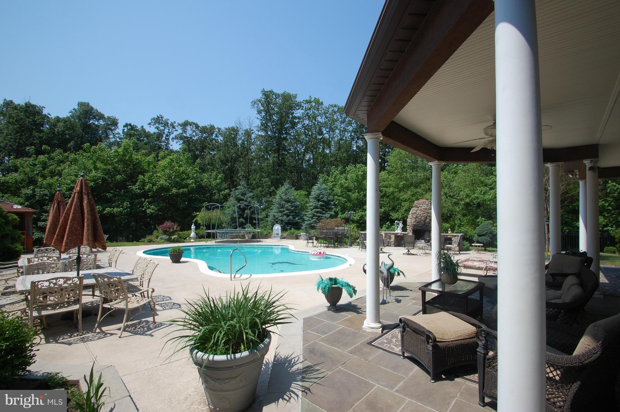3840 Hooper Road New Windsor, MD 21776 - Photo 26 of 30 a view of a patio with couches chairs and potted plants