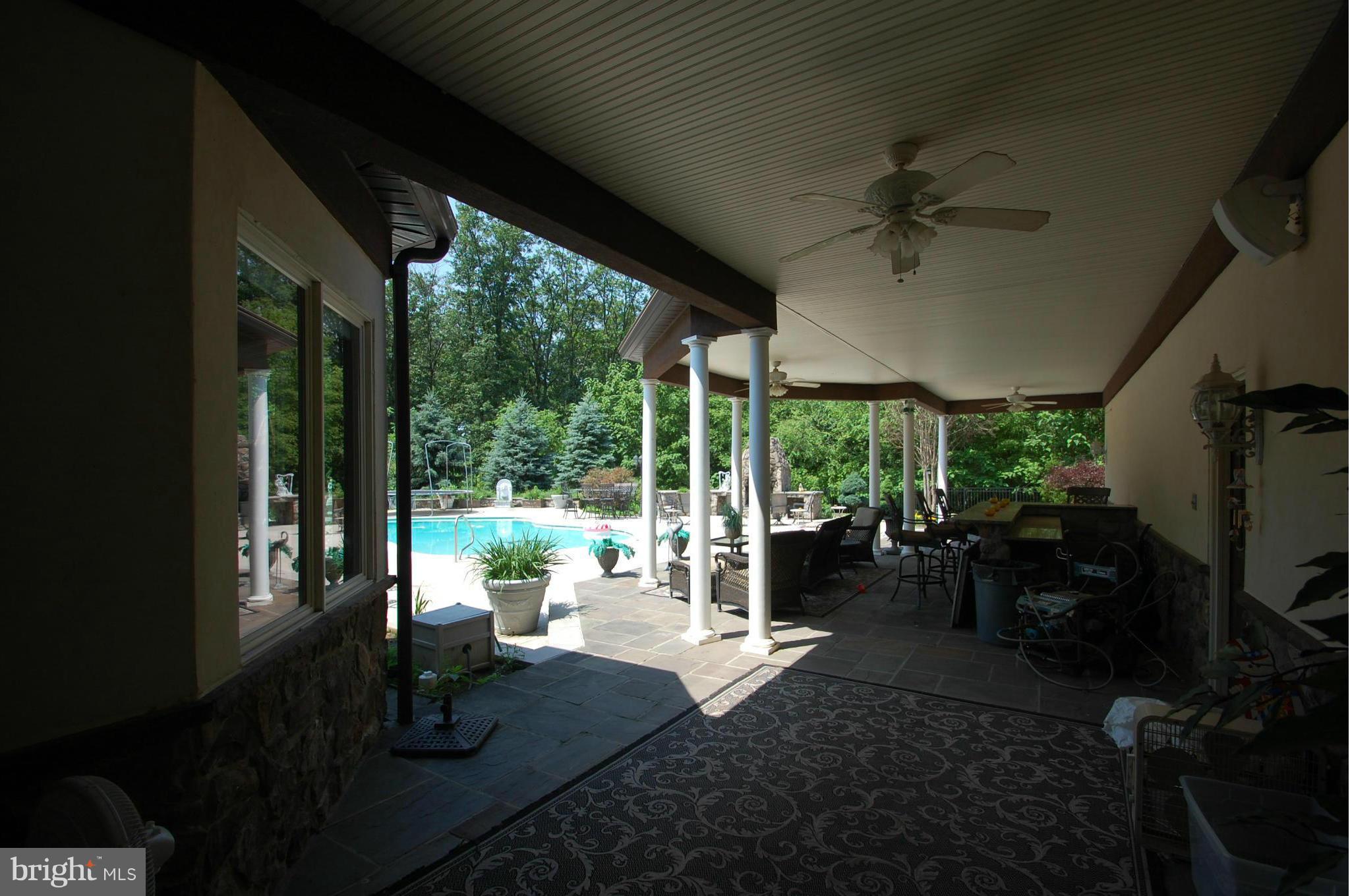 3840 Hooper Road New Windsor, MD 21776 - Photo 27 of 30 a living room with patio fireplace furniture and garden