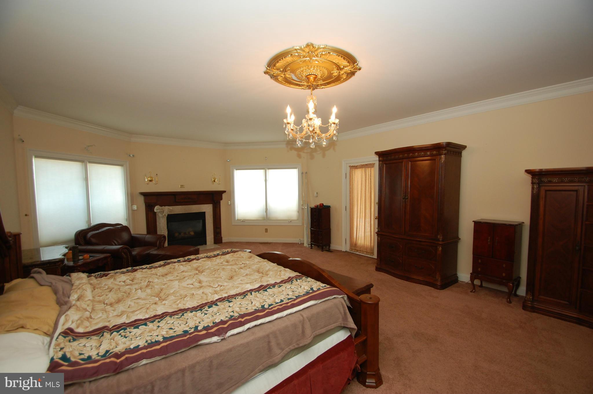 3840 Hooper Road New Windsor, MD 21776 - Photo 7 of 30 a bedroom with a bed and a chandelier