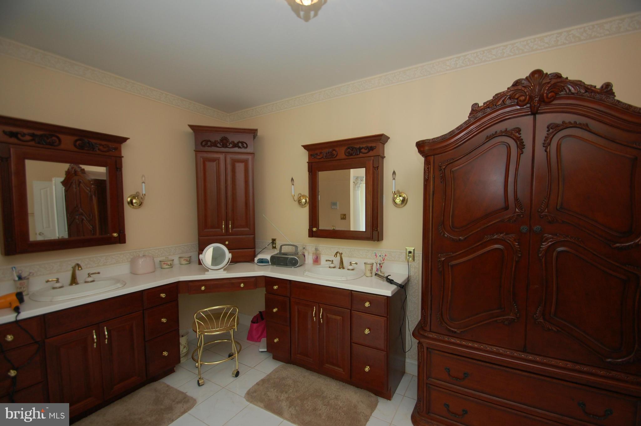 3840 Hooper Road New Windsor, MD 21776 - Photo 10 of 30 a bathroom with double vanity sink a mirror and shower
