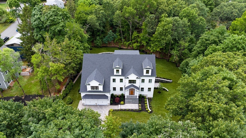 an aerial view of a house with a big yard