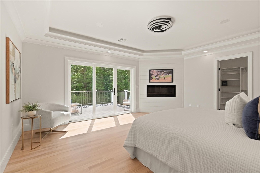 21 Columbus Street Lexington, MA 02421 - Photo 17 of 42 a spacious bedroom with a bed and glass door