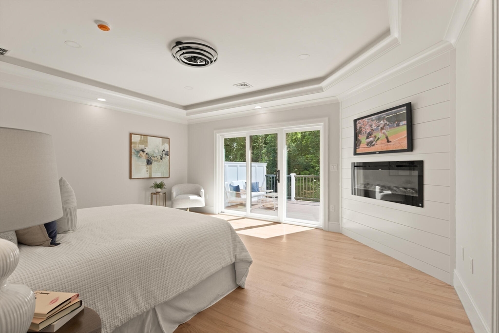 21 Columbus Street Lexington, MA 02421 - Photo 18 of 42 a spacious bedroom with a large bed and a window