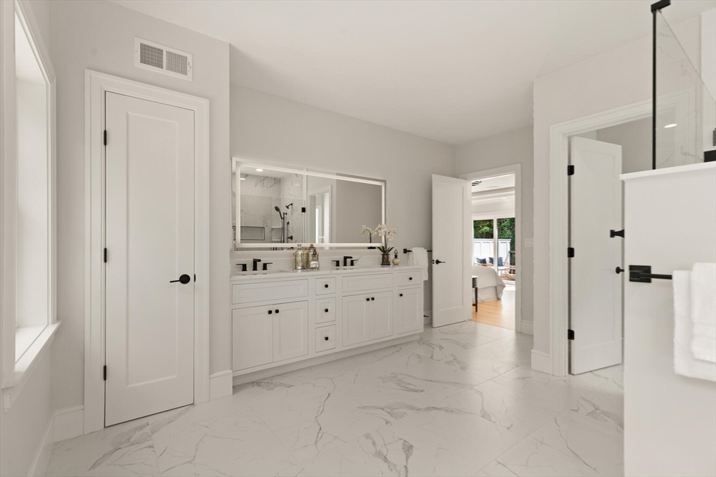 21 Columbus Street Lexington, MA 02421 - Photo 24 of 42 a spacious bathroom with a mirror and a shower