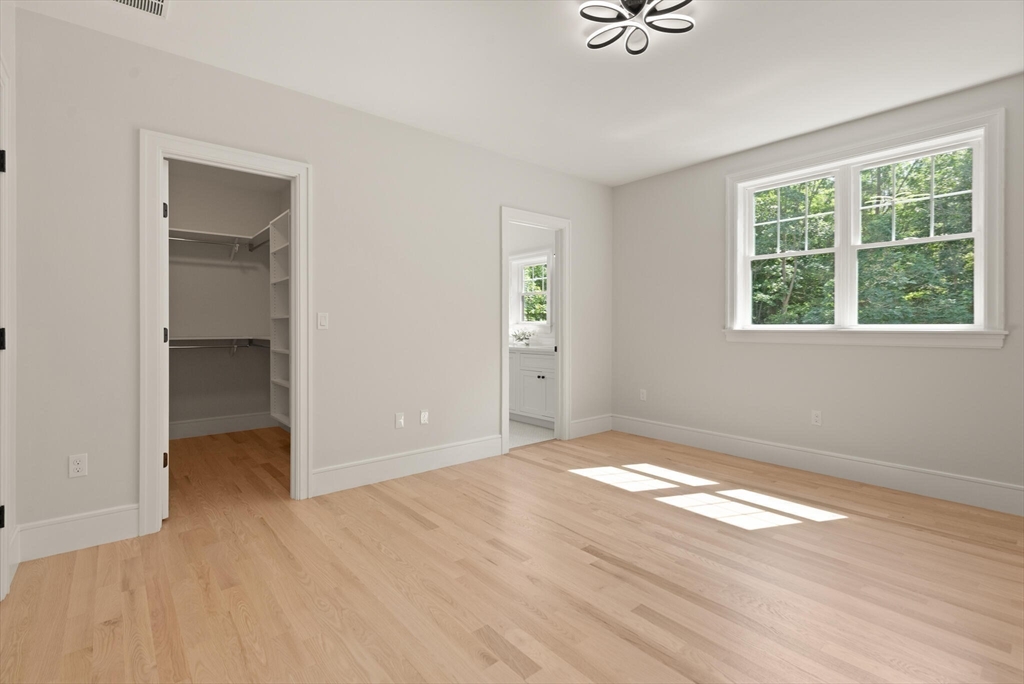 21 Columbus Street Lexington, MA 02421 - Photo 28 of 42 a view of an empty room with wooden floor and a window