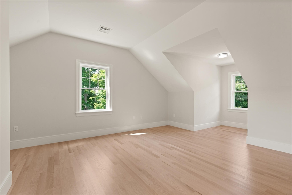 21 Columbus Street Lexington, MA 02421 - Photo 31 of 42 an empty room with wooden floor and windows