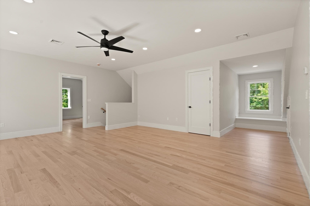 21 Columbus Street Lexington, MA 02421 - Photo 32 of 42 a view of an empty room with a window and wooden floor