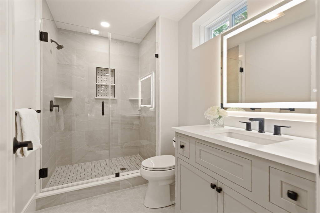 21 Columbus Street Lexington, MA 02421 - Photo 35 of 42 a bathroom with a sink a toilet and shower