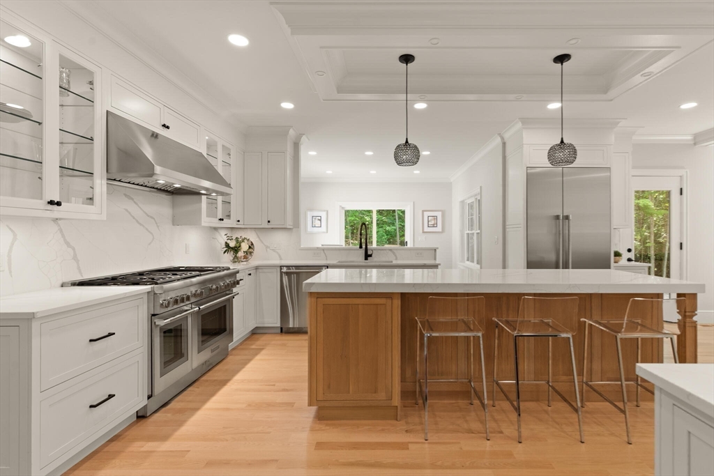 21 Columbus Street Lexington, MA 02421 - Photo 6 of 42 a large kitchen with stainless steel appliances granite countertop a stove and a wooden floors