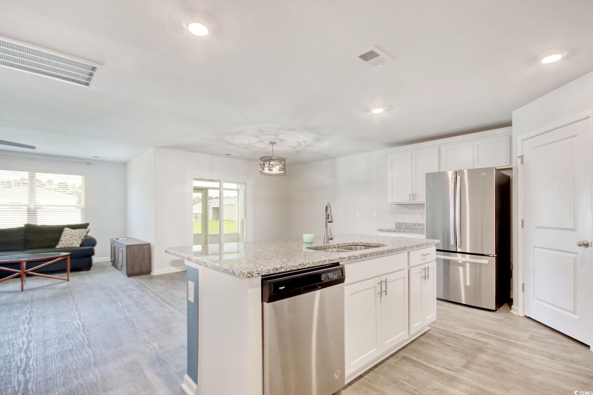 211 Seasons Trace Loop Longs, SC 29568 - Photo 13 of 37 Kitchen featuring stainless steel appliances, healthy amount of natural light, white cabinetry, light wood finished floors, and recessed lighting