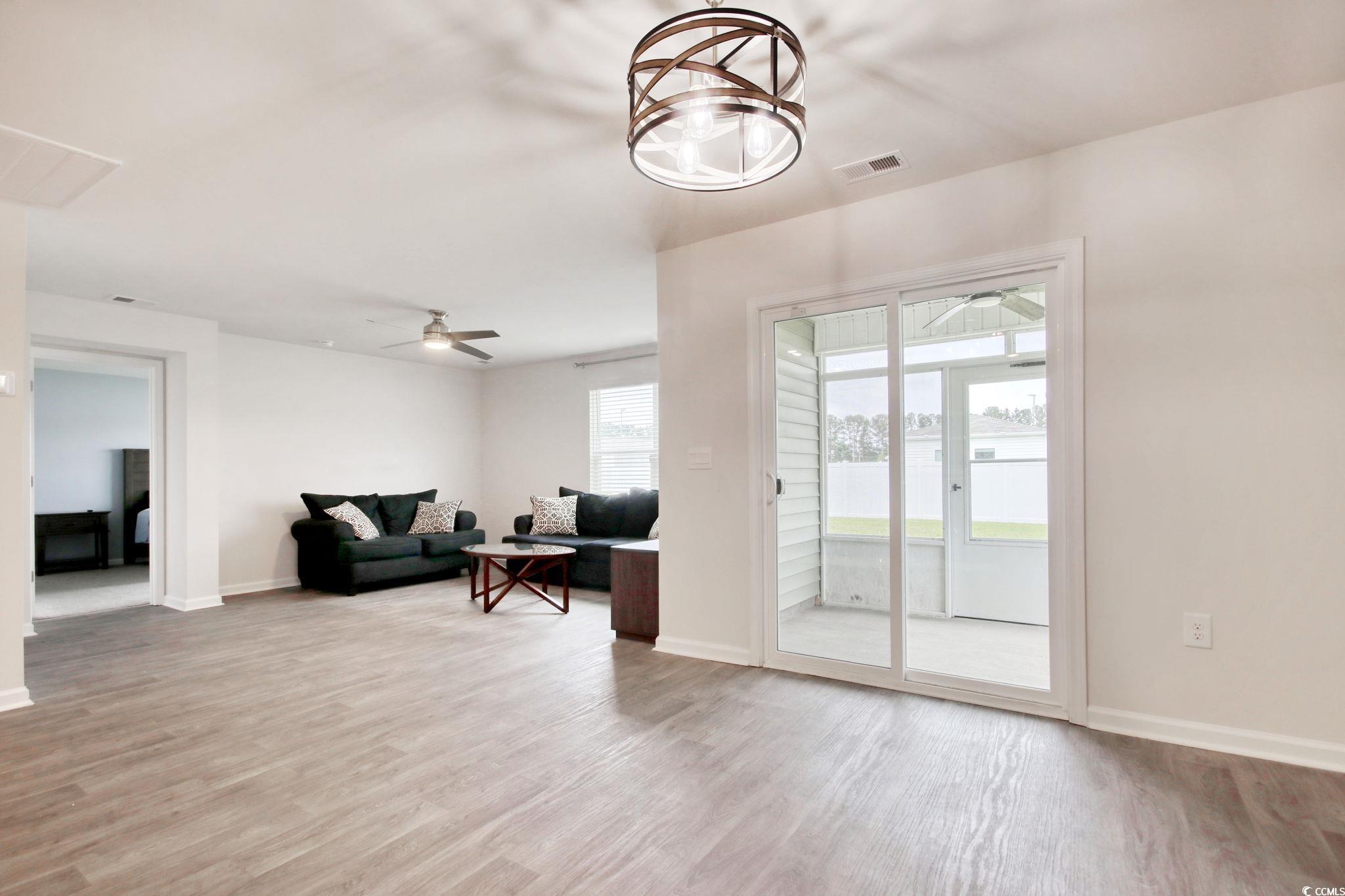 211 Seasons Trace Loop Longs, SC 29568 - Photo 18 of 37 Living room featuring a ceiling fan and light wood-style flooring