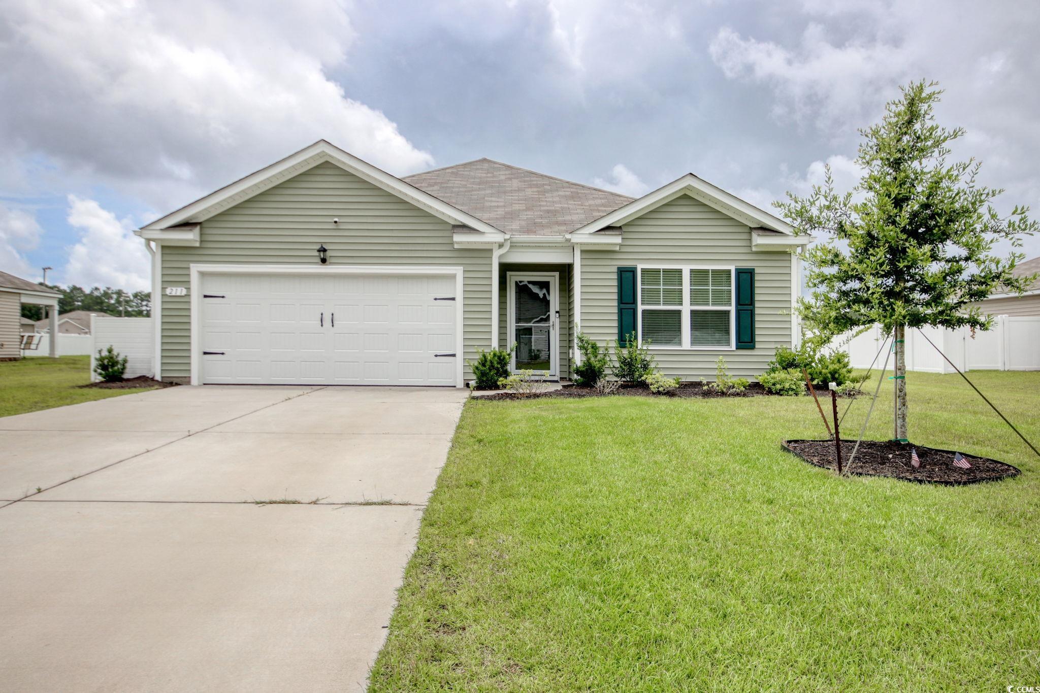 211 Seasons Trace Loop Longs, SC 29568 - Photo 2 of 37 Ranch-style house featuring concrete driveway, an attached garage, and roof with shingles