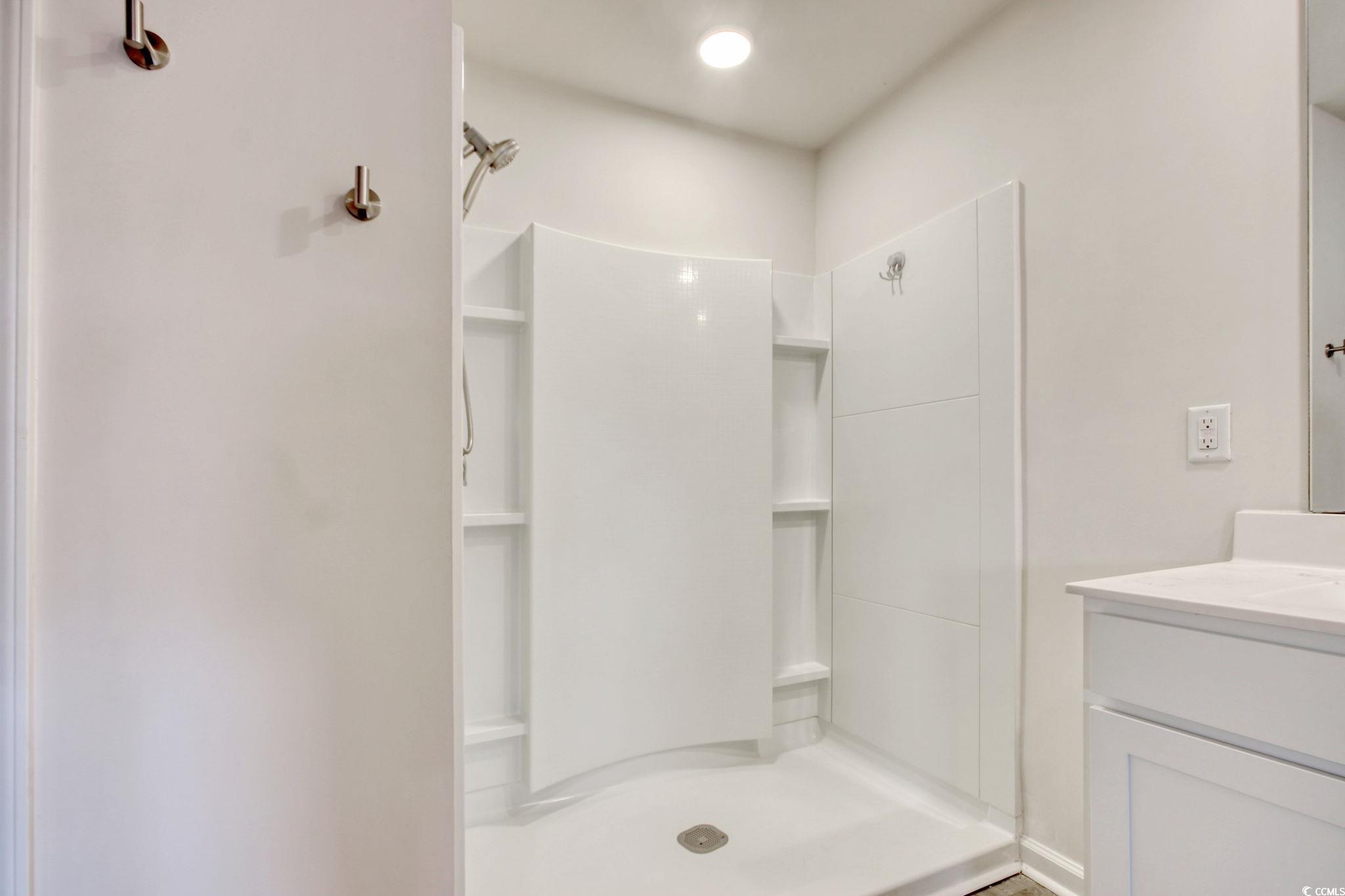 211 Seasons Trace Loop Longs, SC 29568 - Photo 22 of 37 Bathroom with vanity and a shower