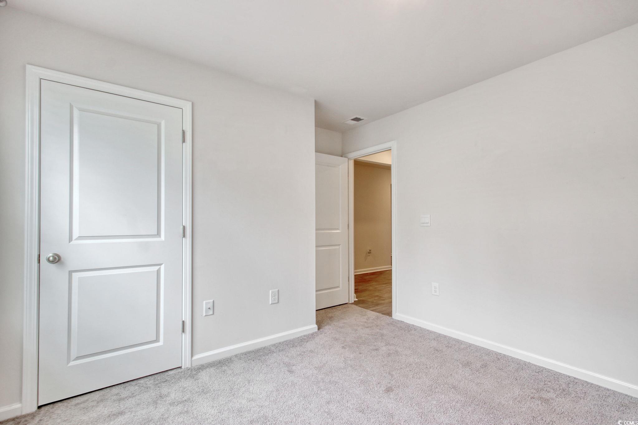 211 Seasons Trace Loop Longs, SC 29568 - Photo 25 of 37 Unfurnished bedroom with baseboards and carpet floors