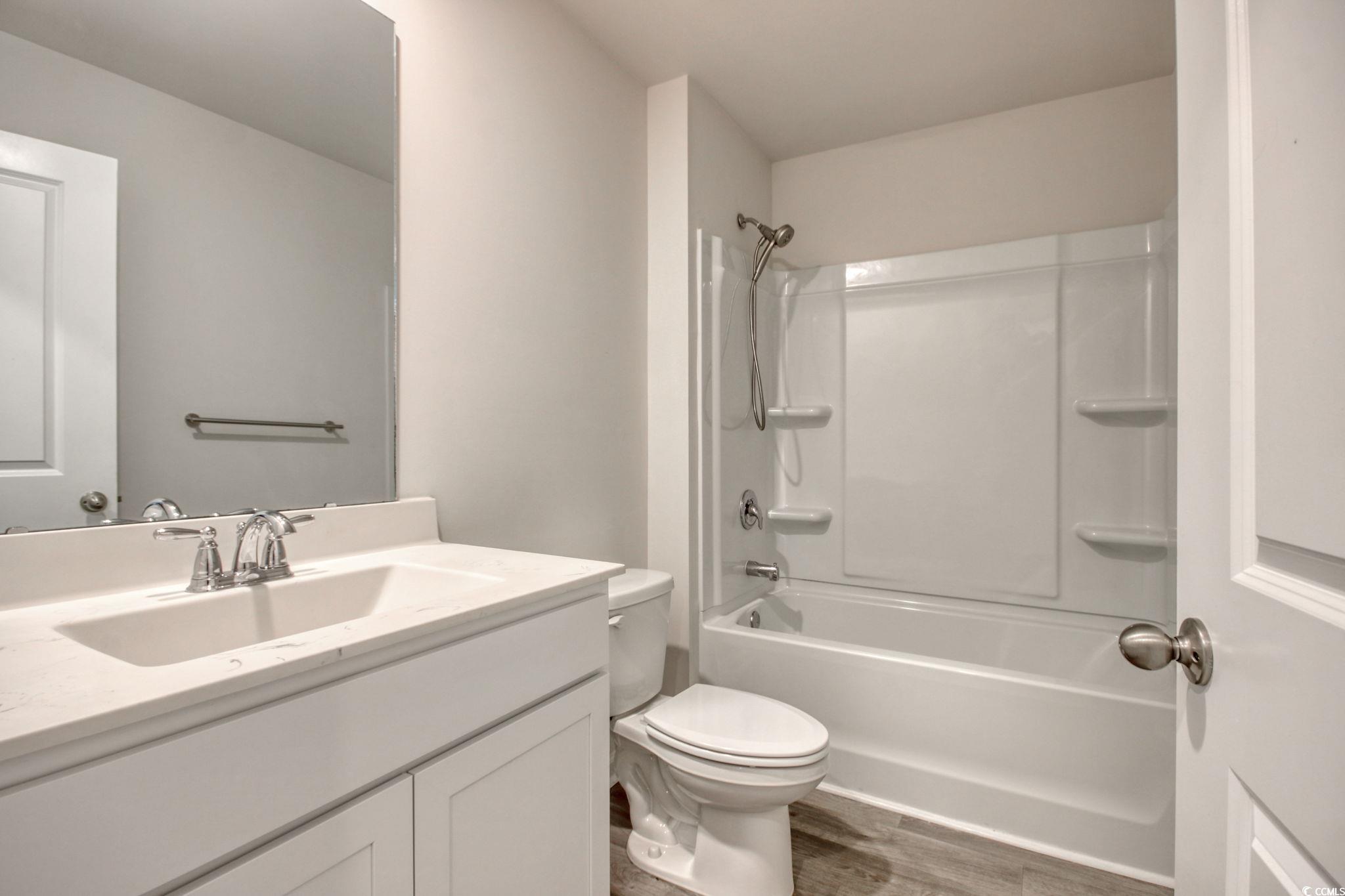 211 Seasons Trace Loop Longs, SC 29568 - Photo 26 of 37 Bathroom featuring vanity, wood finished floors, and shower / bathtub combination