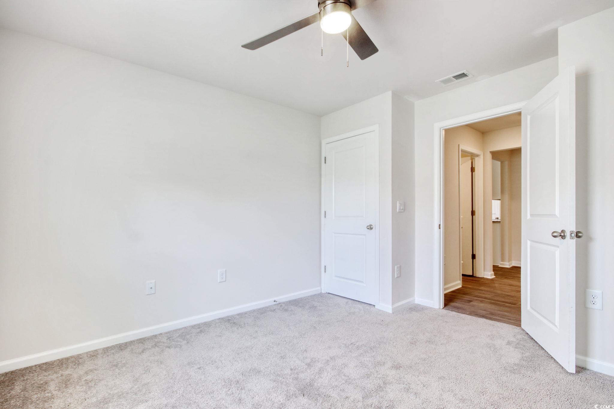 211 Seasons Trace Loop Longs, SC 29568 - Photo 27 of 37 Unfurnished bedroom featuring carpet floors and a ceiling fan