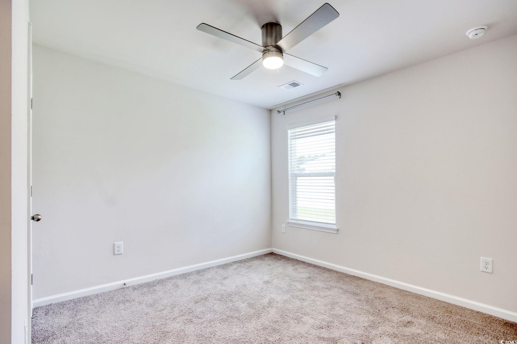 211 Seasons Trace Loop Longs, SC 29568 - Photo 29 of 37 Unfurnished room with carpet floors, a smoke detector, and ceiling fan