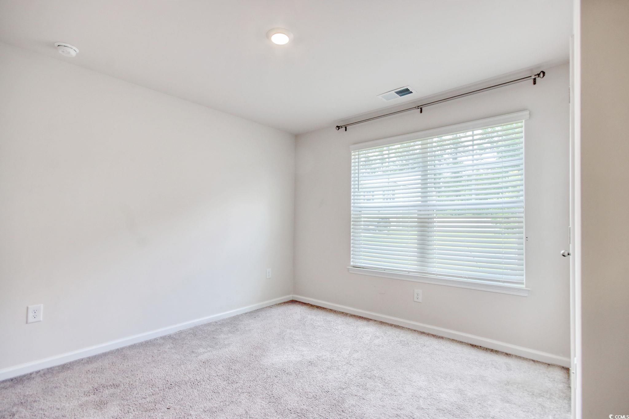 211 Seasons Trace Loop Longs, SC 29568 - Photo 30 of 37 Empty room with carpet floors and a smoke detector