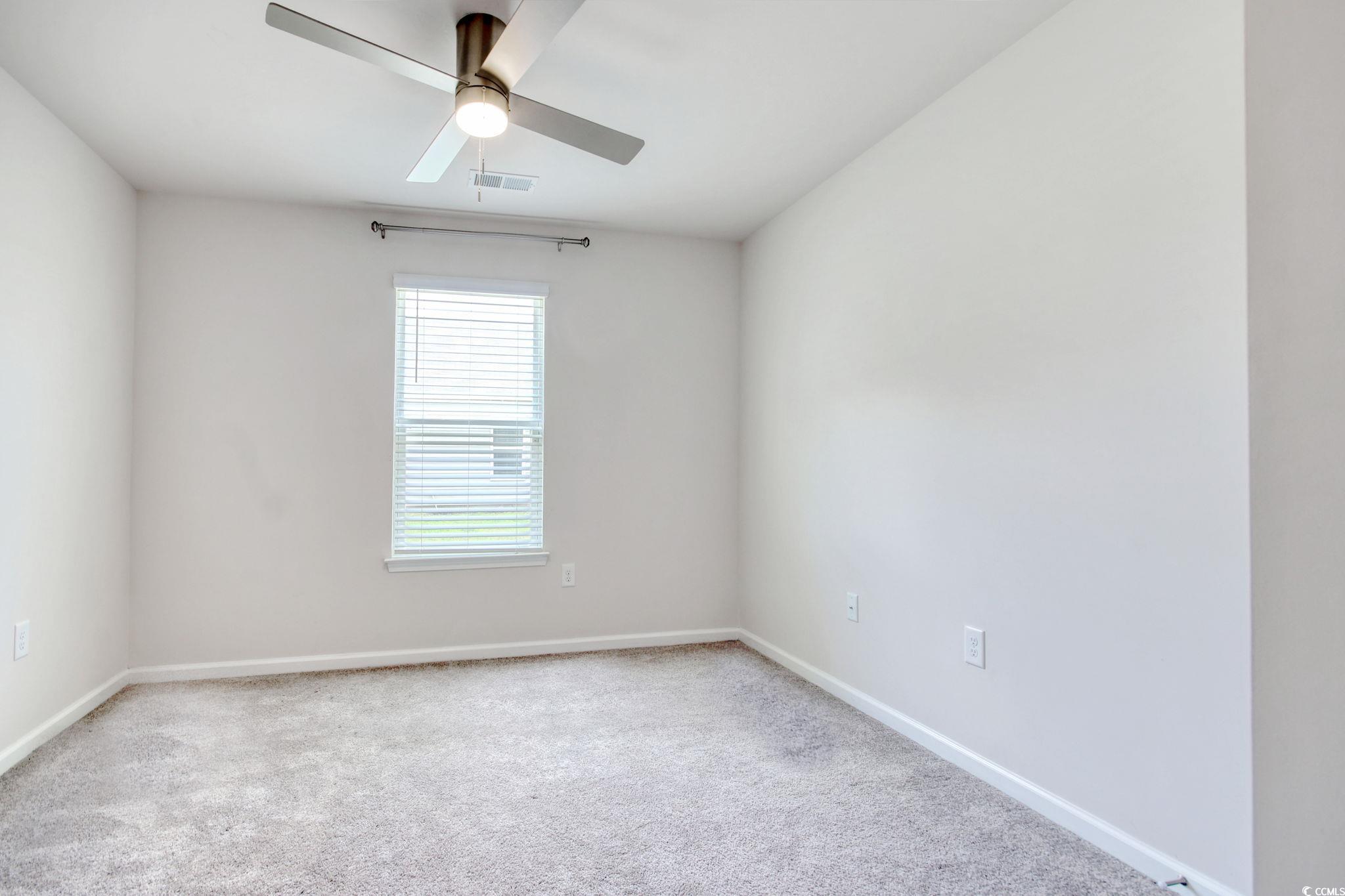 211 Seasons Trace Loop Longs, SC 29568 - Photo 31 of 37 Carpeted spare room with baseboards and a ceiling fan