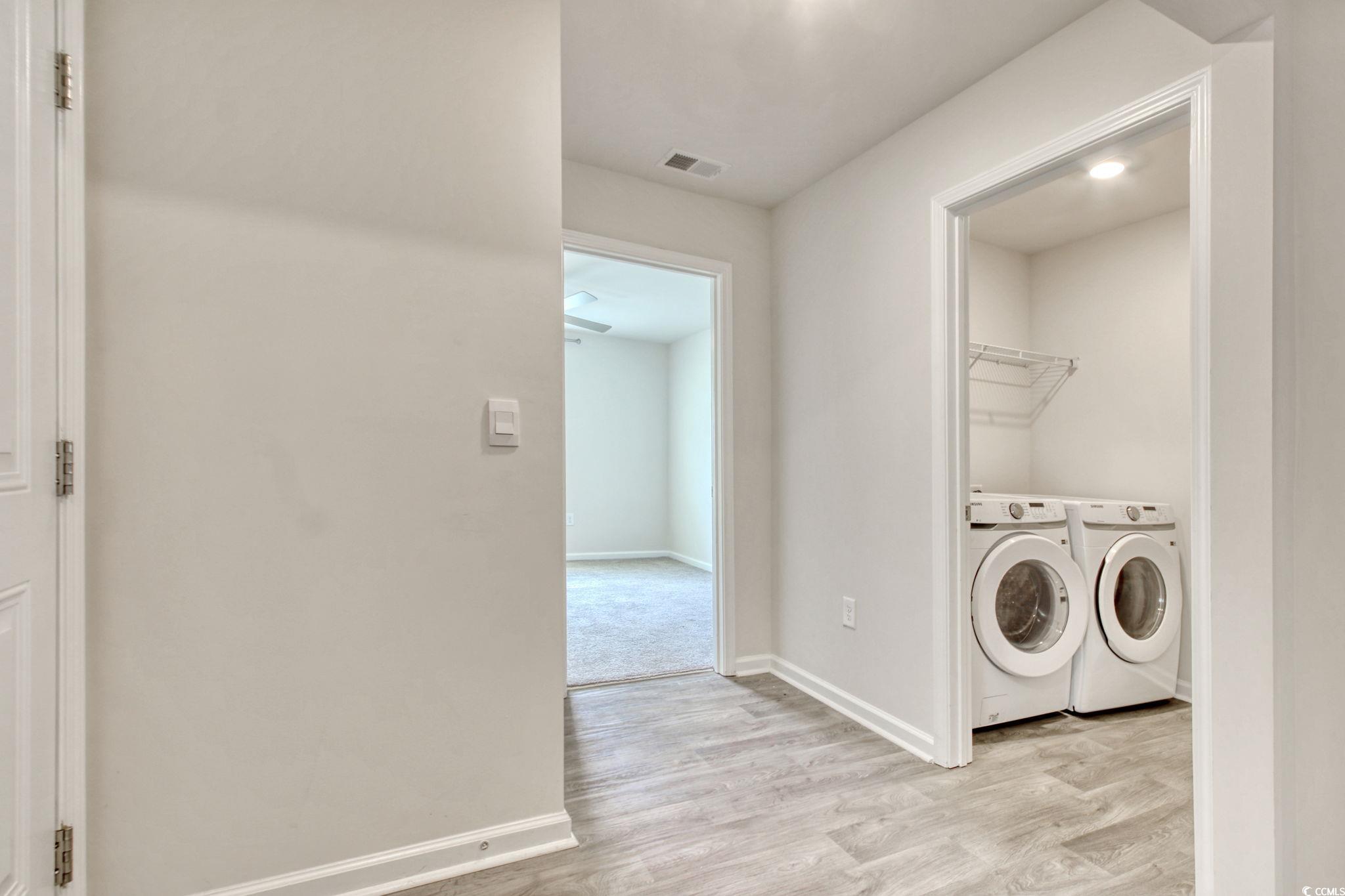 211 Seasons Trace Loop Longs, SC 29568 - Photo 33 of 37 Laundry area with washing machine and dryer and light wood-type flooring