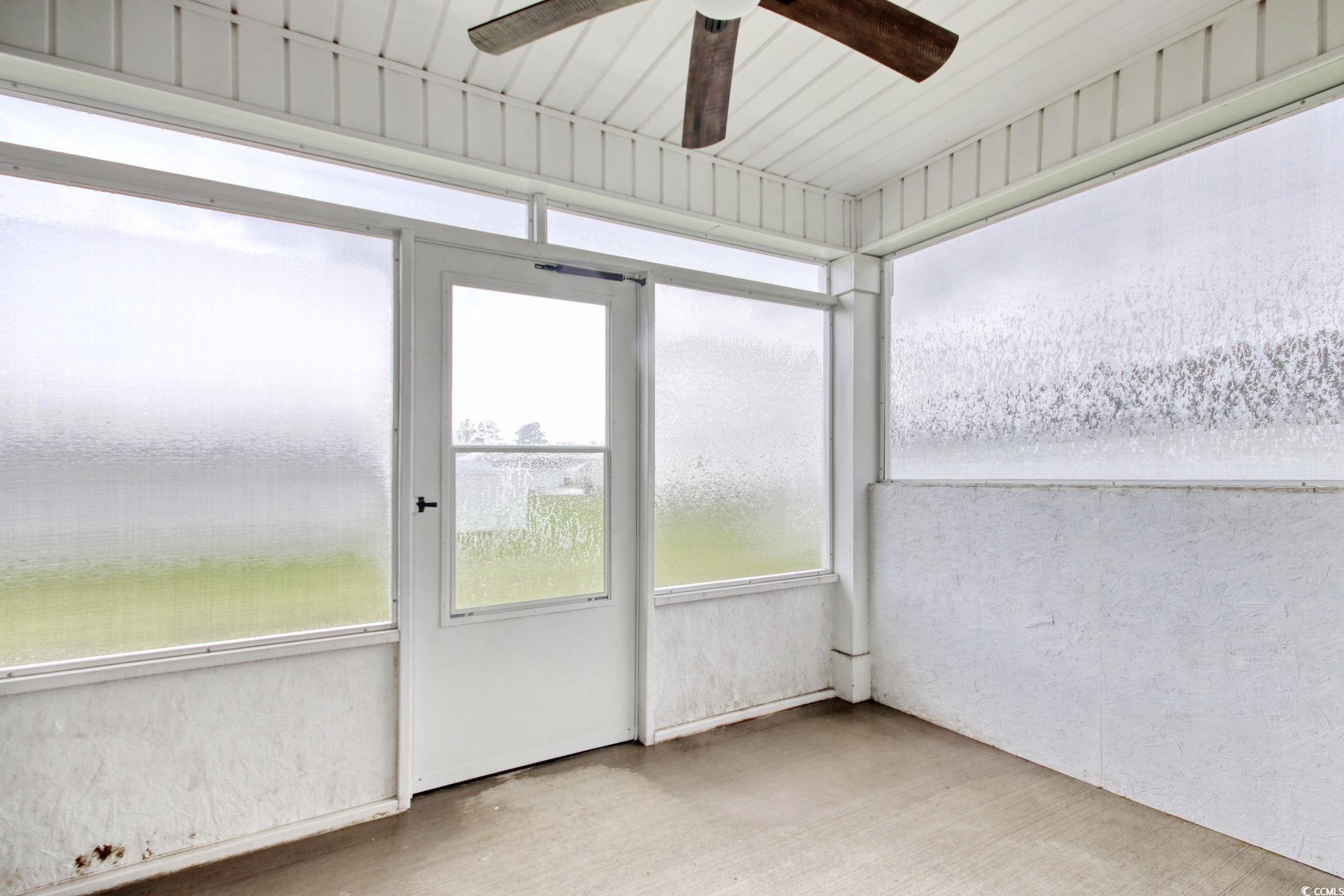 211 Seasons Trace Loop Longs, SC 29568 - Photo 35 of 37 Unfurnished sunroom with ceiling fan