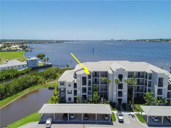 a aerial view of a house with a garden and lake view