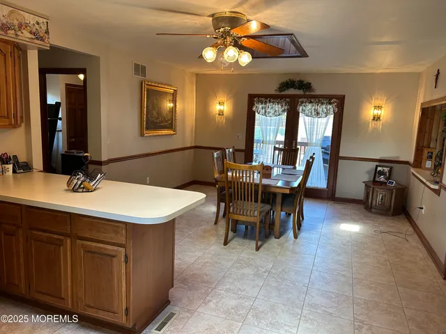 a view of a dining room with furniture and chandelier