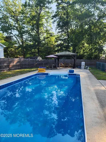 a swimming pool with outdoor seating and yard