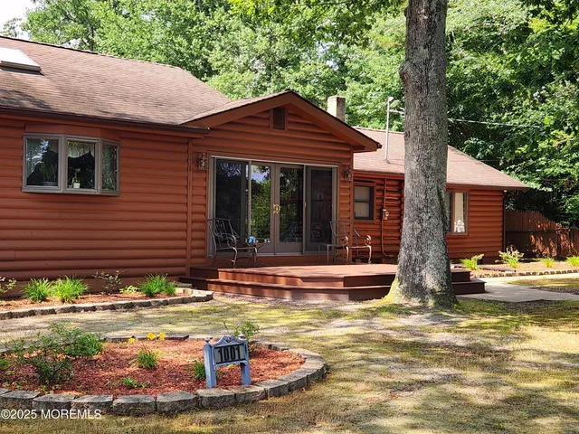 a view of a house with pool and sitting area