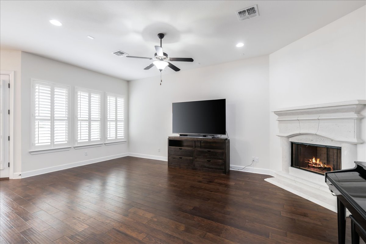600 Garner Park Drive Georgetown, TX 78628 - Photo 15 of 39 Unfurnished living room featuring dark wood-style flooring, recessed lighting, a fireplace, and ceiling fan