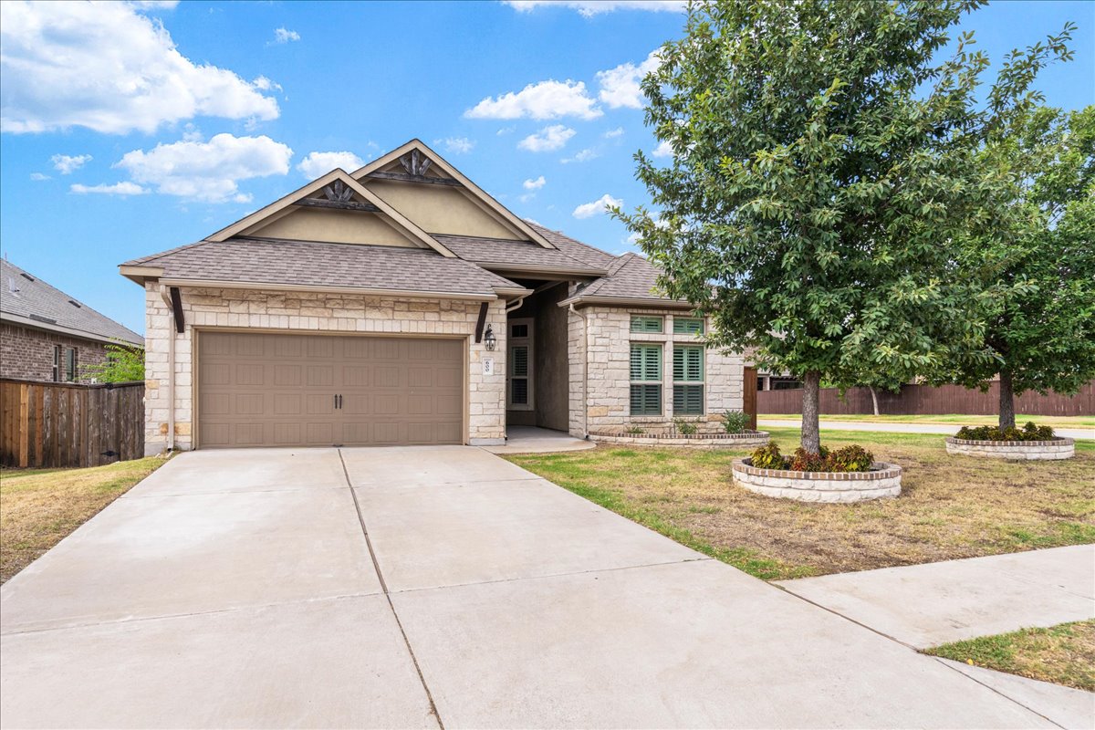 600 Garner Park Drive Georgetown, TX 78628 - Photo 2 of 39 View of front of house featuring stone siding, roof with shingles, a garage, and concrete driveway
