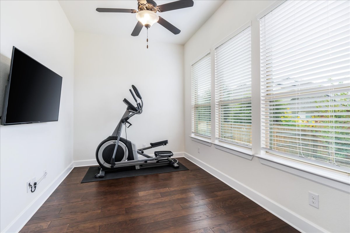 600 Garner Park Drive Georgetown, TX 78628 - Photo 24 of 39 Exercise room with dark wood-style flooring and ceiling fan