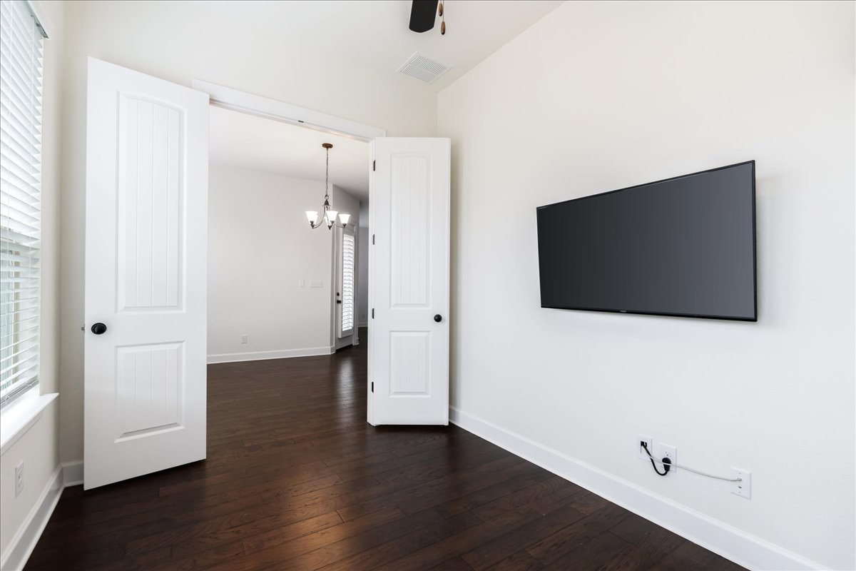 600 Garner Park Drive Georgetown, TX 78628 - Photo 25 of 39 Unfurnished living room featuring a chandelier and dark wood-type flooring