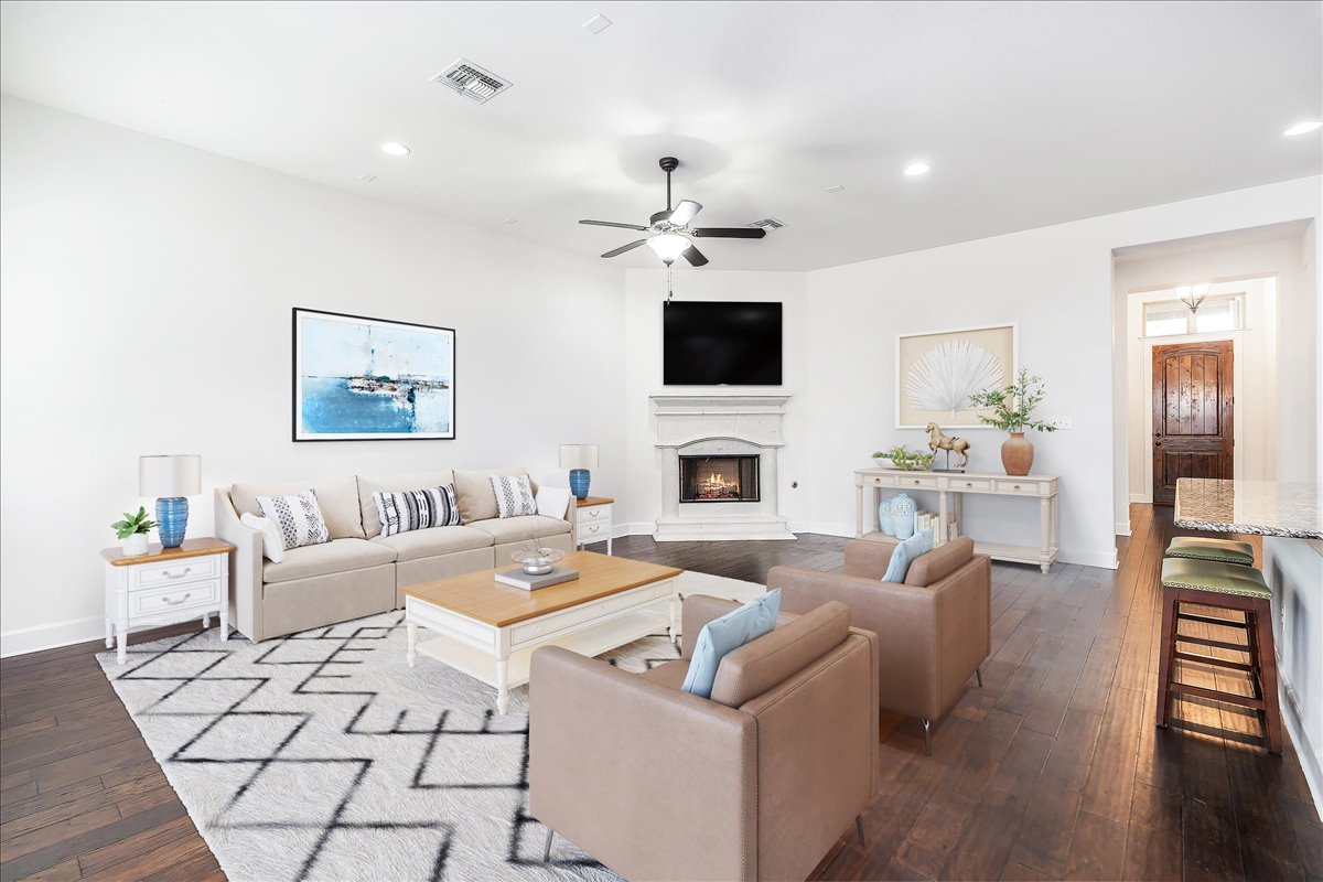 600 Garner Park Drive Georgetown, TX 78628 - Photo 33 of 39 Living room with a warm lit fireplace, dark wood-style floors, a ceiling fan, and recessed lighting