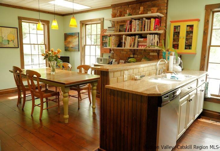 15 Hewlett Road Red Hook, NY 12571 - Photo 11 of 29 a kitchen with stainless steel appliances granite countertop a table chairs and a dining table