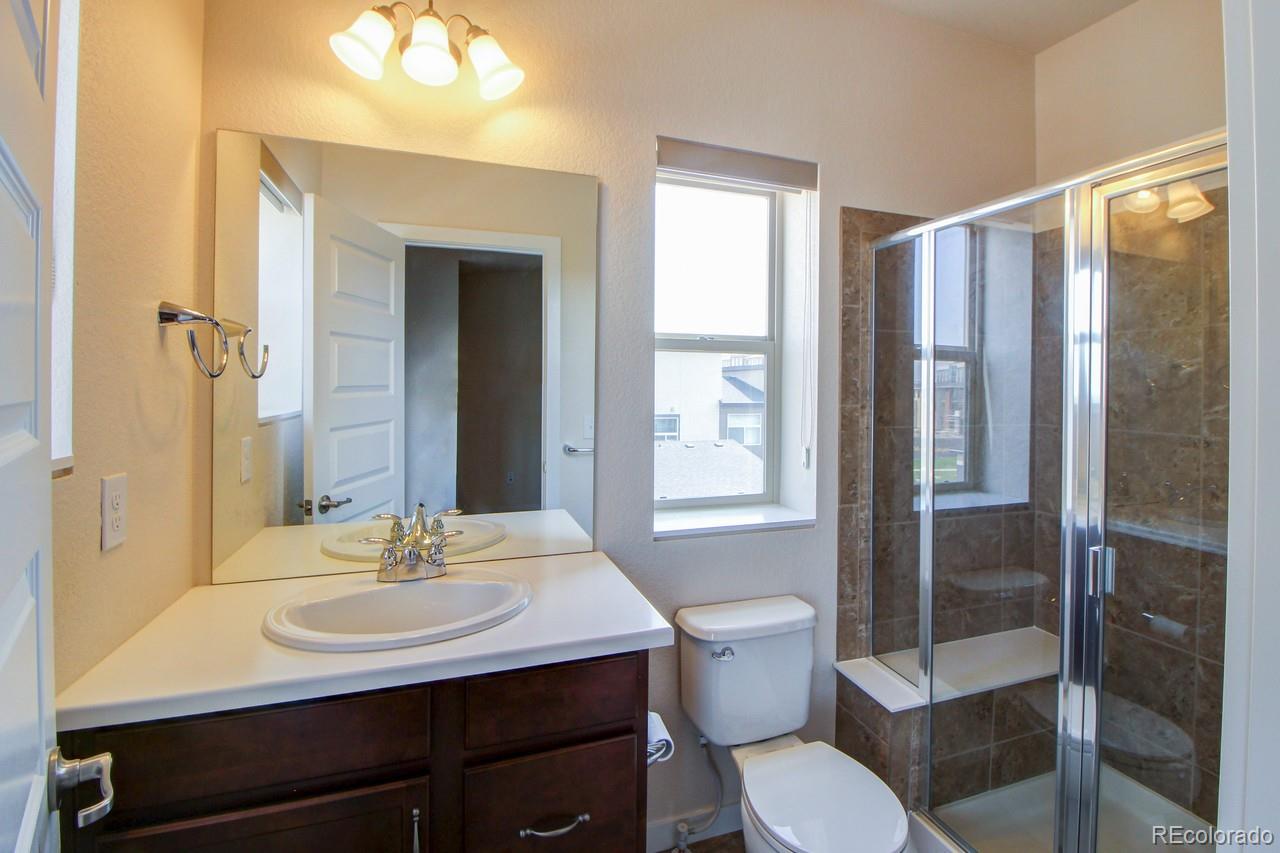 10122 Belvedere Loop Lone Tree, CO 80124 - Photo 12 of 17 a bathroom with a sink toilet and shower