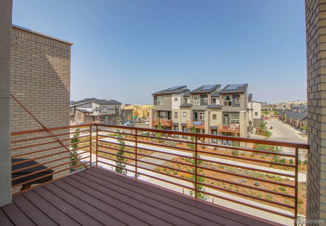 10122 Belvedere Loop Lone Tree, CO 80124 - Photo 2 of 17 a view of a balcony with wooden floor and city view