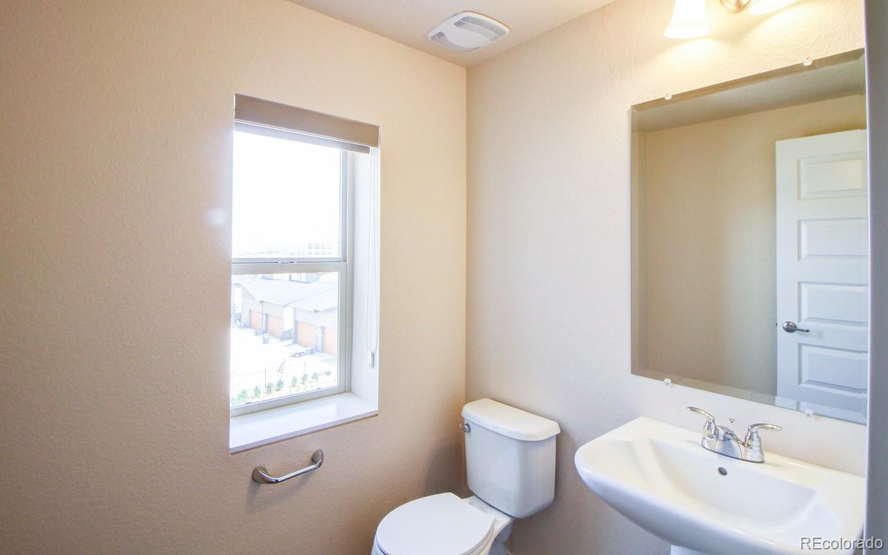 10122 Belvedere Loop Lone Tree, CO 80124 - Photo 9 of 17 a bathroom with a toilet sink and mirror