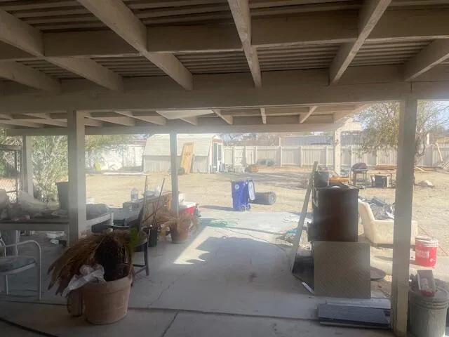 a backyard of a house with table and chairs