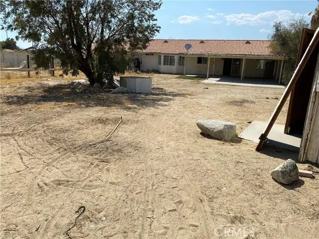 a view of a chairs and table in backyard