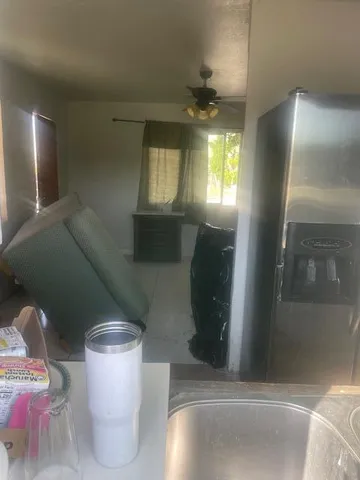 a kitchen with granite countertop a refrigerator and a sink