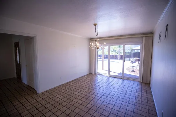an empty room with a window and a fireplace