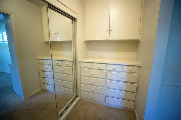 a bathroom with a sink a toilet a window and vanity